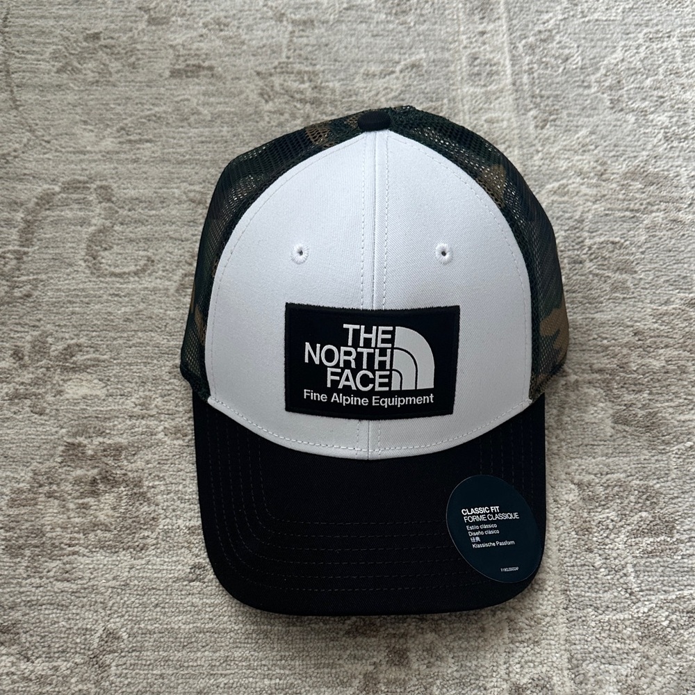 The North Face Men’s Mudder Trucker White/Black with Camo back. NWT’s